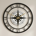 Decorative wall clock with compass design on a plain background